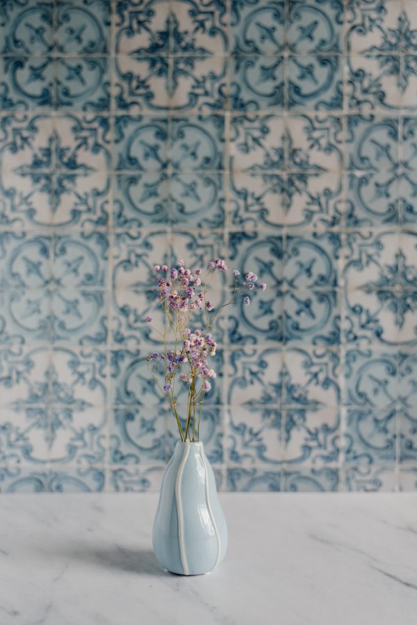 blue vase with colorful gypsophila on a background of blue azulejos tiles